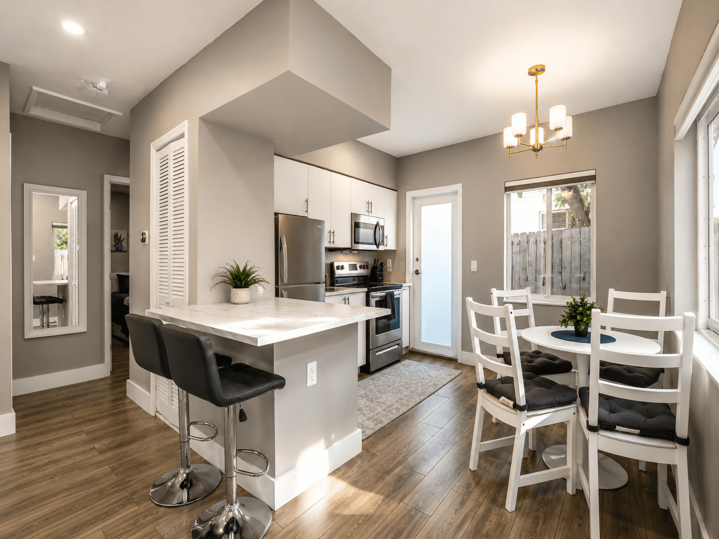 Kitchen and island with warm white cabinetry