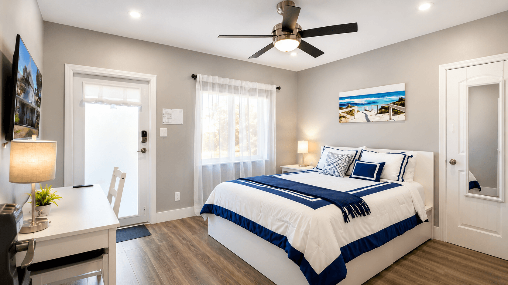 Primary suite with queen bed and layered ivory linens